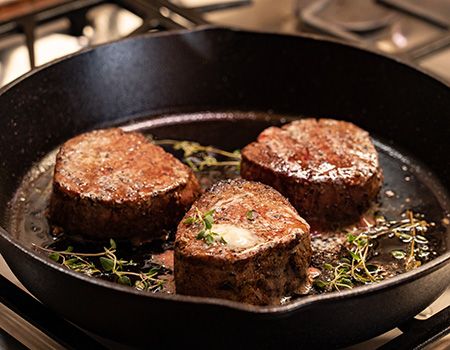 Cook steaks.