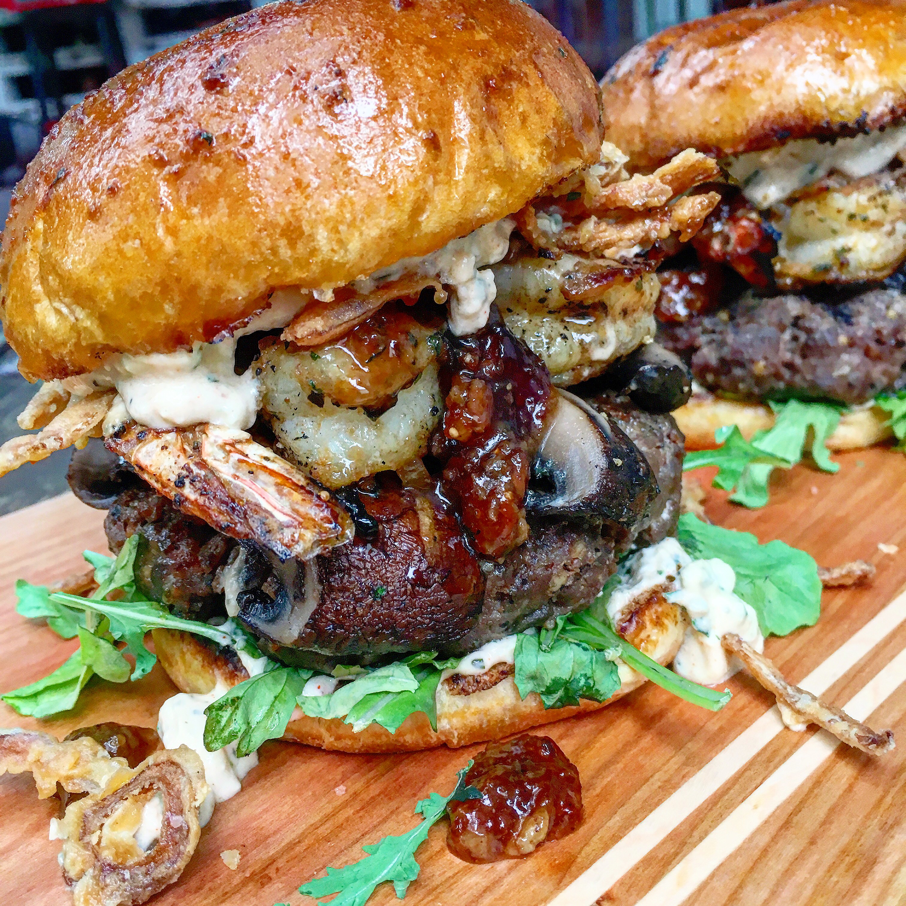 Smokey Sweet Surf and Turf Burgers with Grilled Portobellos Gorgonzola Aioli Bacon Fig Jam and Fried Red Onions Recipe